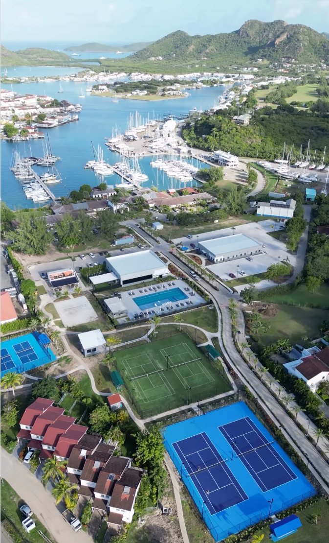 Courts, pool, marina and yachts at Jolly Harbour, Antigua